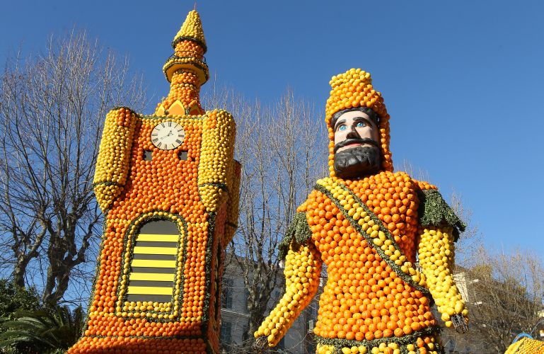 A picture shows sculptures made with oranges and lemons representing a "beffroi" (Belfry) and a "giant" symbolising the Northern region of France on February 16, 2012 in Menton on the French Riviera, ahead of the start of the "Fete du Citron" (lemon carnival). The theme of this 79th edition, running from February 17 until March 07, 2012, is "French regions". AFP PHOTO / VALERY HACHE